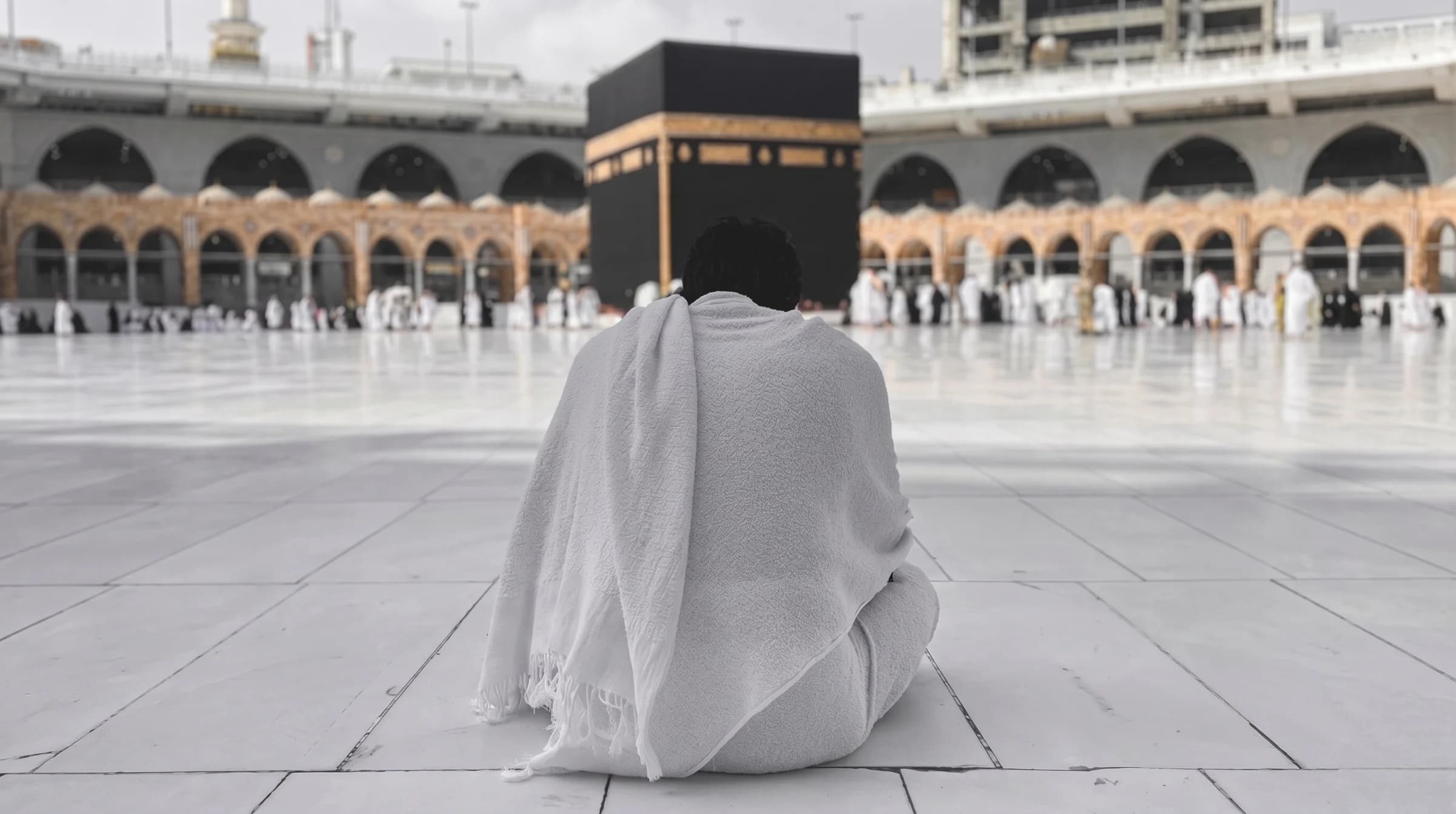 Pilgrim facing the Kaaba at Masjid al-Haram