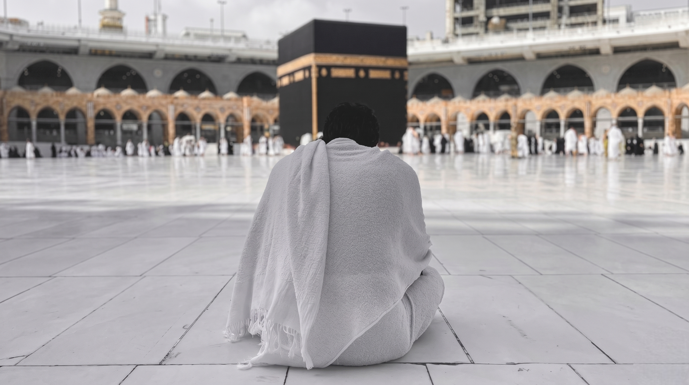Pilgrim facing the Kaaba at Masjid al-Haram